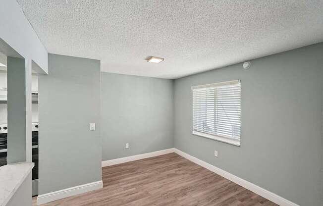 A room with a window and wooden floors.