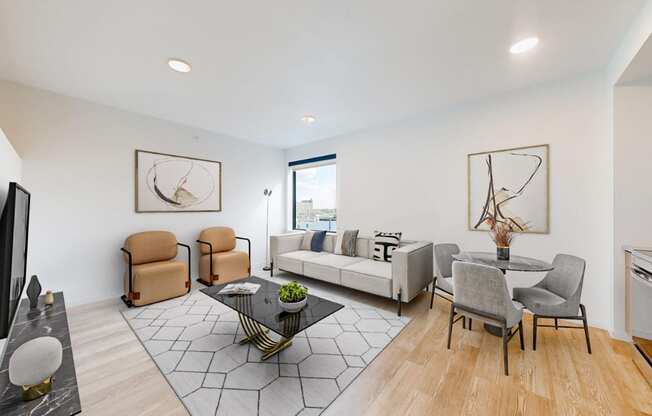 a living room with a couch and a table with chairs