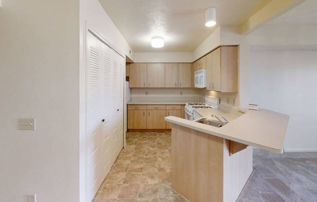 a kitchen with wooden cabinets and white appliances