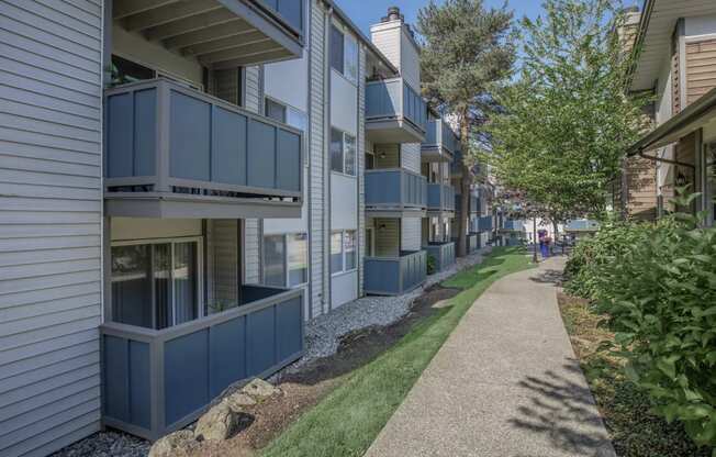 a shaded walkway between two buildings at Foster Creek apartments