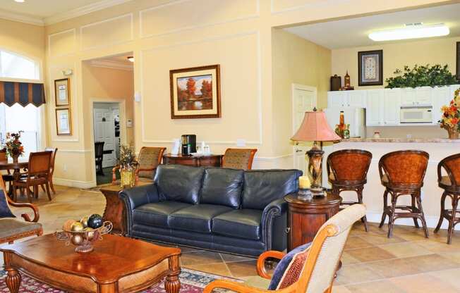 A living room with a blue couch and wooden furniture.