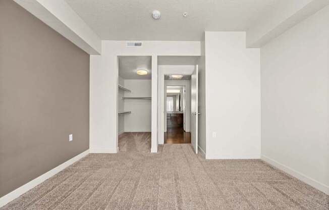 a spacious living room with gray walls and a carpeted floor at Wilmington Flats Apartments, Salt Lake City