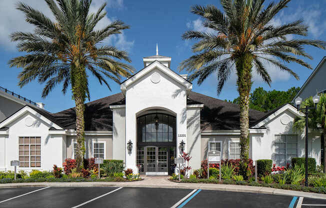 a building with palm trees in front of it