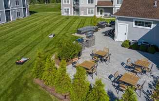 Outdoor patio, grills, fire pit, and cornhole