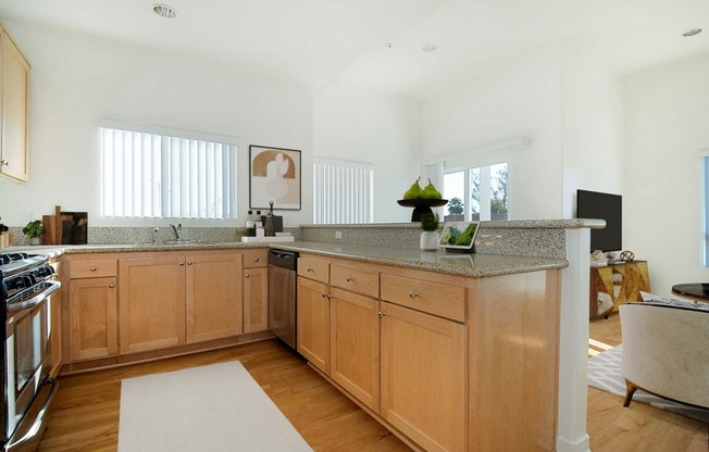 a large kitchen with wooden cabinets and a counter top