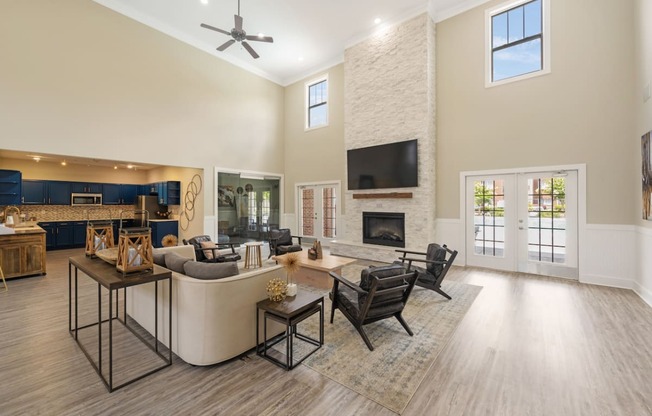 a living room with a couch and chairs and a fireplace