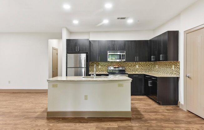 a large kitchen with a large island in the middle of it at Lakeline East Apartments, Cedar Park, 78613