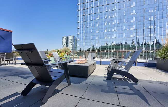 a patio with two chairs and a table on a rooftop