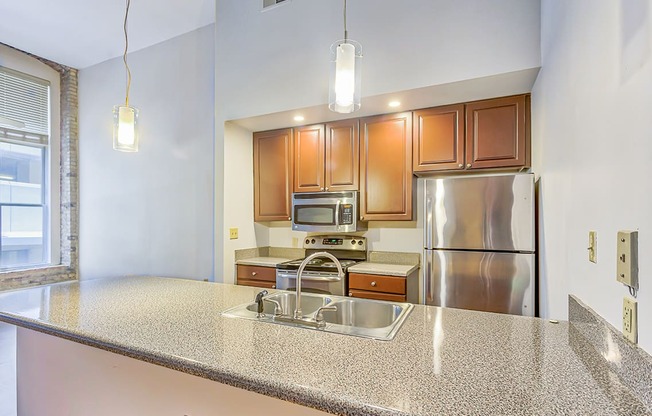 a kitchen with granite countertops and stainless steel appliances