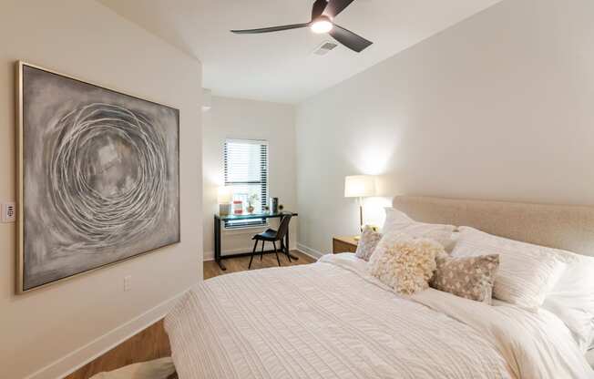 a bedroom with a large bed and a ceiling fan  at Century West Pryor, Lee's Summit