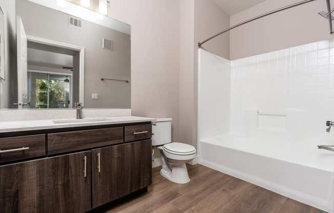 Apartments in Spring Valley for Rent - Alicante - Bathroom with Bath Tub, Shower, Wood-Style Flooring, and Large Mirror