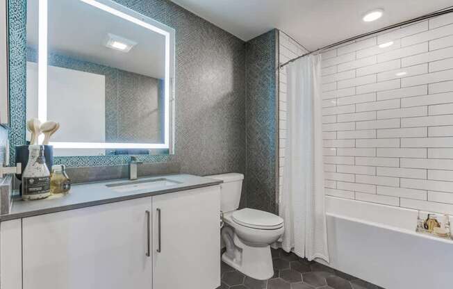 A white toilet sits next to a bathtub in a bathroom.
