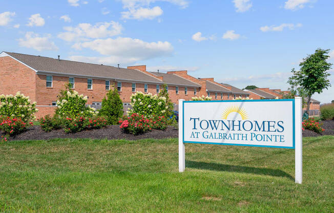 a picture of the townhomes at calgary pointe sign in front of the building