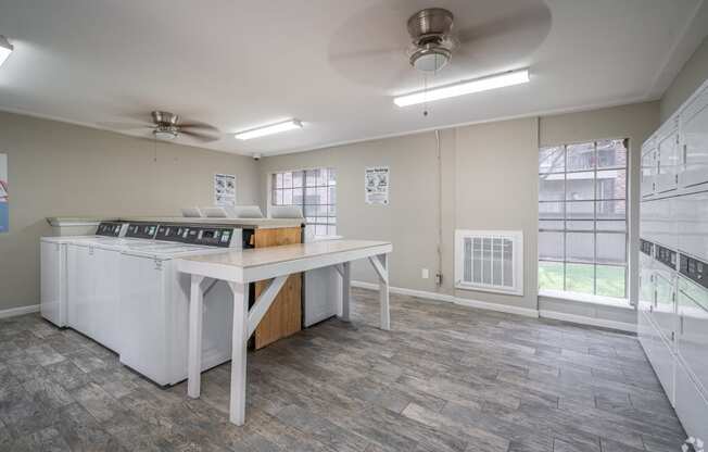 an empty kitchen with an island and a stove and a window