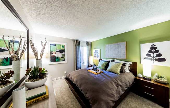 Bedroom with dresser and nightstand with breakfast tray on bed