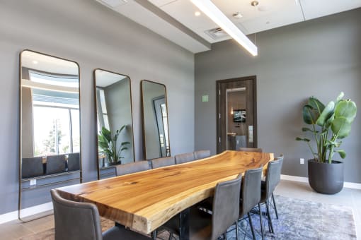conference room at Main Street Lofts Cupertino a large wooden table with chairs in a room with gray walls
