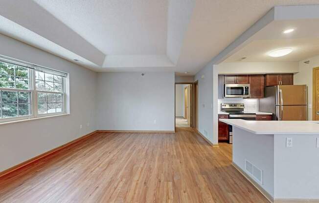 A large empty room with wooden floors and white walls.