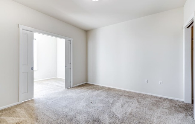 a bedroom with white walls and carpet