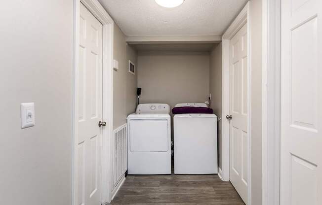 A small laundry room with a washer and dryer.