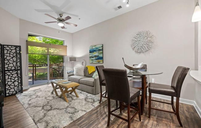 a dining room and living room with a table and chairs