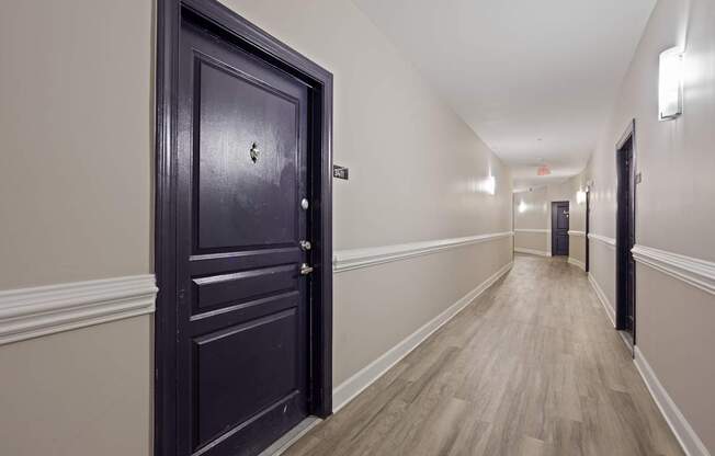 Flatiron West Trade Apartments black door in hallway