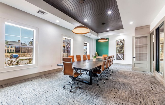 A conference room with a long table and chairs.