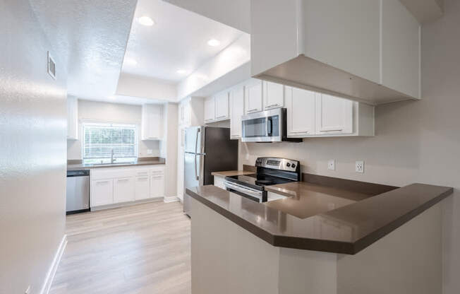 A modern kitchen with a refrigerator, microwave, and oven. at Harbor Pointe, Dana Point, 92629