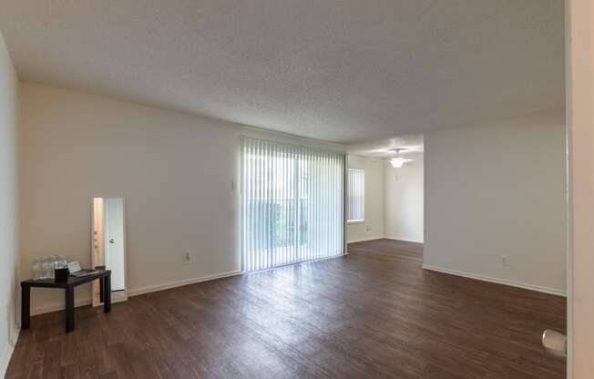 This is a photo of the living room and entryway in the 871 square foot 2 bedroom, 2 bath apartment at Princeton Court Apartments in the Vickery Meadow neighborhood of Dallas, Texas.