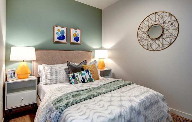 Apartments for Rent Seattle - Metroline Flats - Bedroom with Stylish Decor, Wood-Style Flooring, and Sage Green Accent Wall