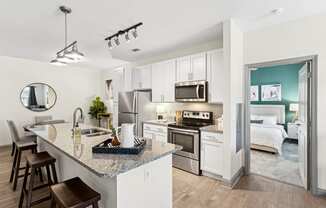 a kitchen with stainless steel appliances and a granite counter top