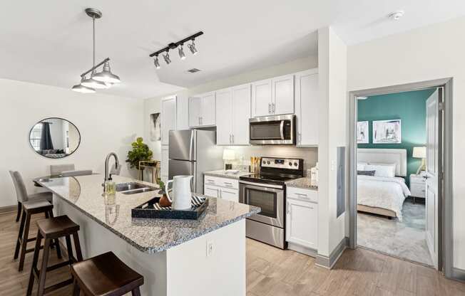 a kitchen with stainless steel appliances and a granite counter top