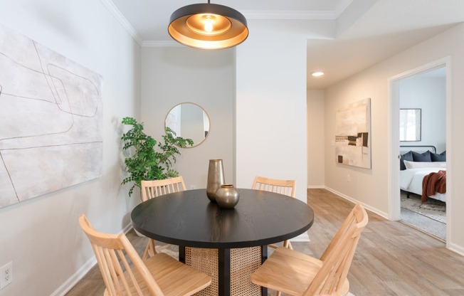 a dining room with a table and chairs