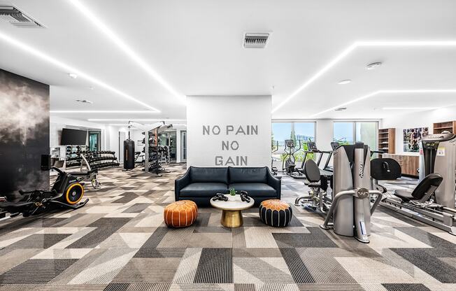 a workout room with a large sign that says no pain no gain