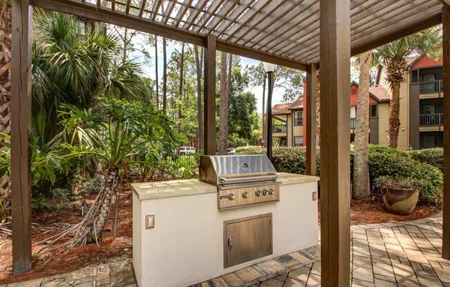 a covered patio with a gas grill