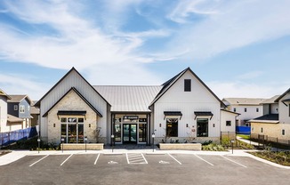 the exterior of a church with a parking lot