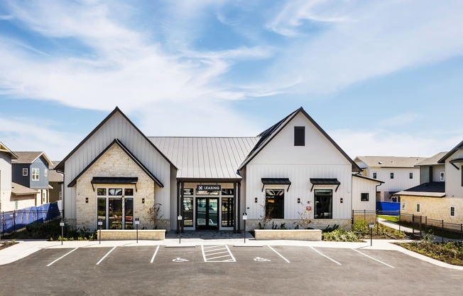 the exterior of a church with a parking lot