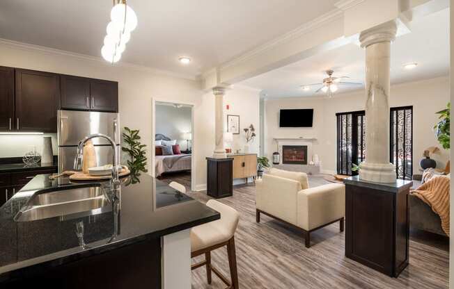 a kitchen and living room with a couch and a table at Arlo Luxury homes Apartments, Arkansas