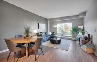 A modern dining room with a wooden table and chairs.