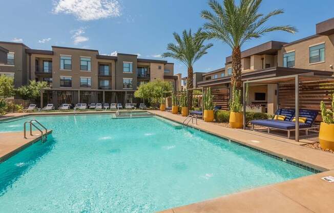 A swimming pool in front of apartment buildings.