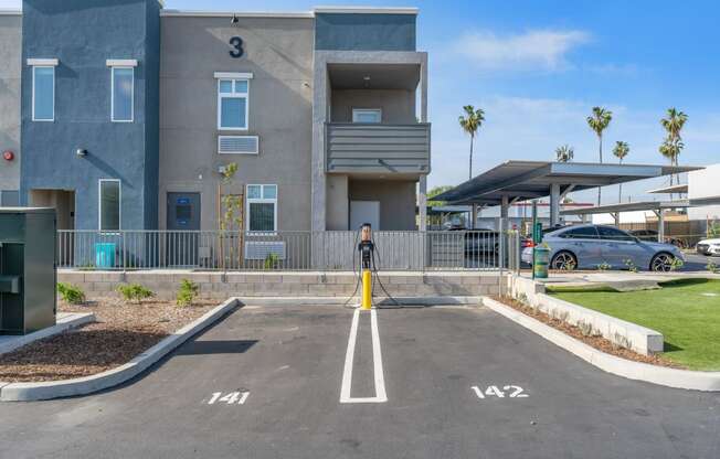 a parking lot at the whispering winds apartments in pearland, tx at Loma Villas Apartments, San Bernardino, CA