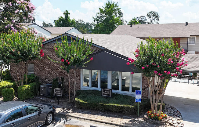 A car is parked in front of a building with a sign that says