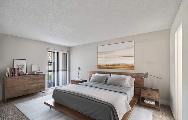 Model Bedroom with Carpet and Patio Accessibility at Madison Park Apartments located in Anaheim, CA.