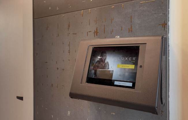 A wall-mounted television displays an advertisement for a luxury product.