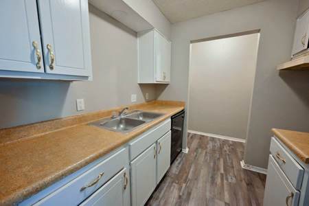 A kitchen with light blue cabinets and a brown counter top.