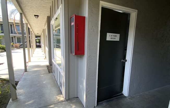 the door to the building is open and the hallway is empty