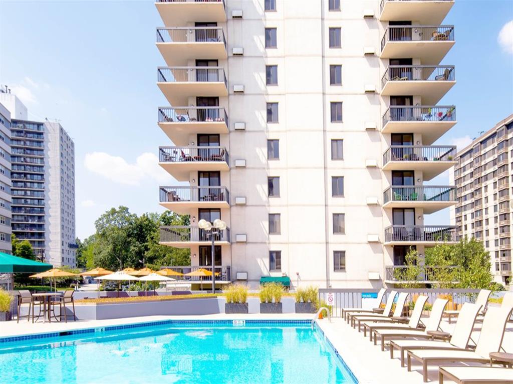 Luxury, resort-style pool with poolside chairs at Prospect Place, NJ 07601