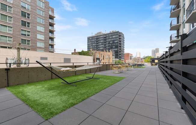 a grassy area with a hammock on the roof of a building
