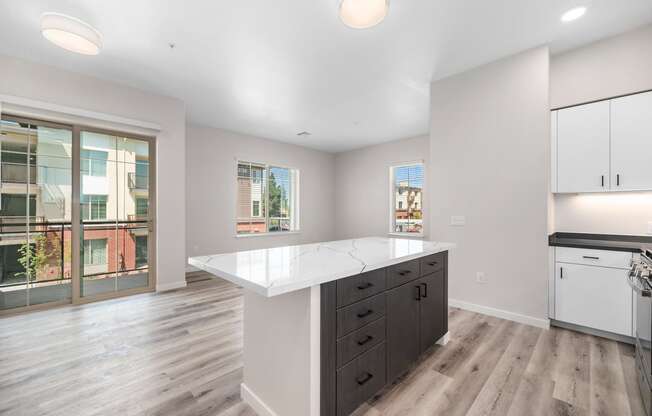 an open kitchen with white countertops and a large island