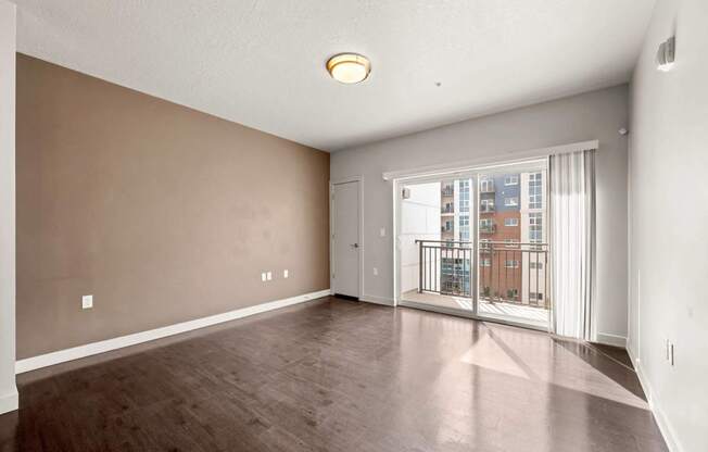 a bedroom with hardwood flooring and a balcony at Wilmington Flats Apartments, Salt Lake City, 84106