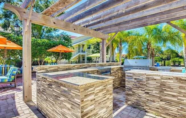 a backyard with a hot tub and a pergola